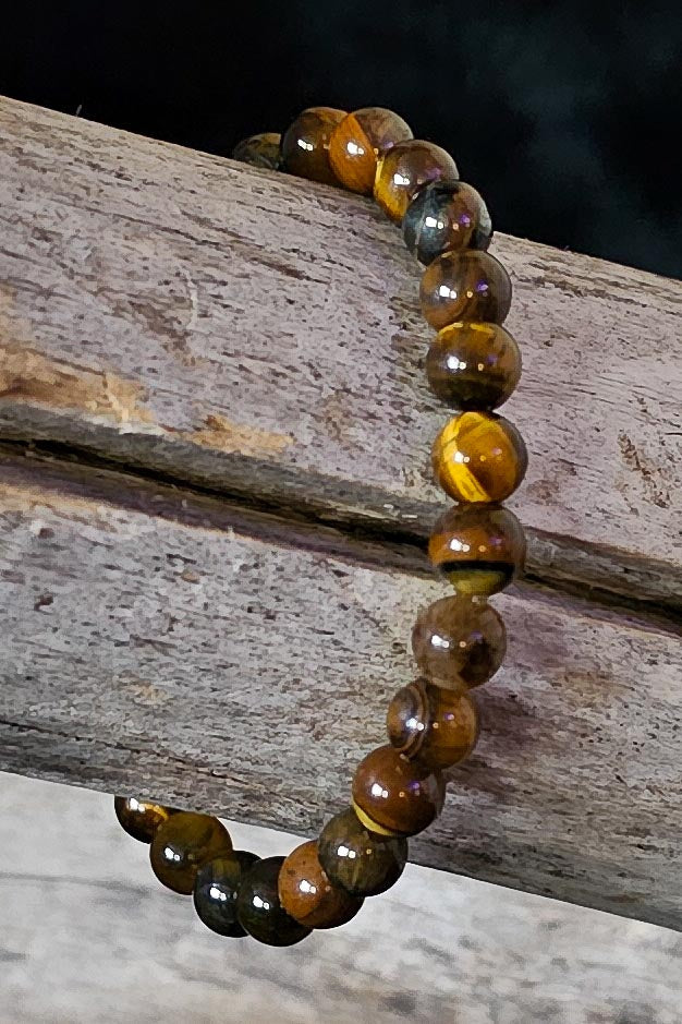 Aaron handcrafted tiger's eye gemstone beaded bracelet on a wooden surface — Amelia Heir Art