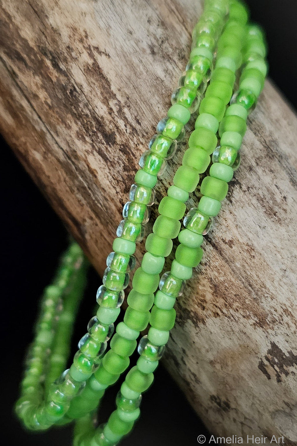 Alice handcrafted vivid green & fluorescent beaded bracelet set on a wooden surface — Amelia Heir Art