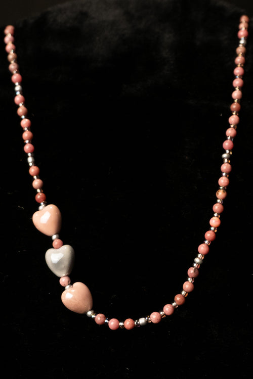 Necklace with heart-shaped beads on a black background