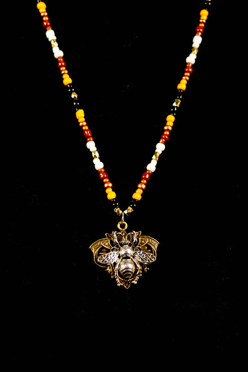 Necklace with a bee-shaped pendant on a black background