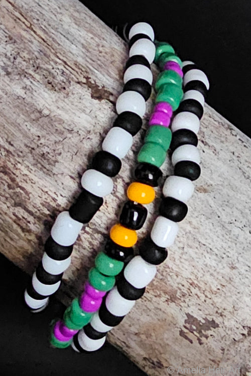 Colorful beaded bracelets on a wooden surface