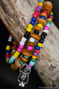 Colorful beaded bracelet with a silver  lantern charm on a wooden surface
