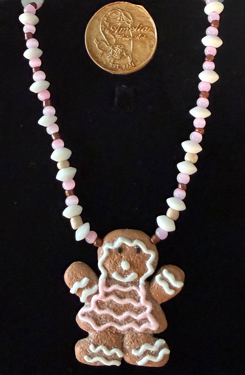 Clara gingerbread woman cookie pendant necklace with pink, white, and brown beads — handmade holiday jewelry by Amelia Heir Art Designs