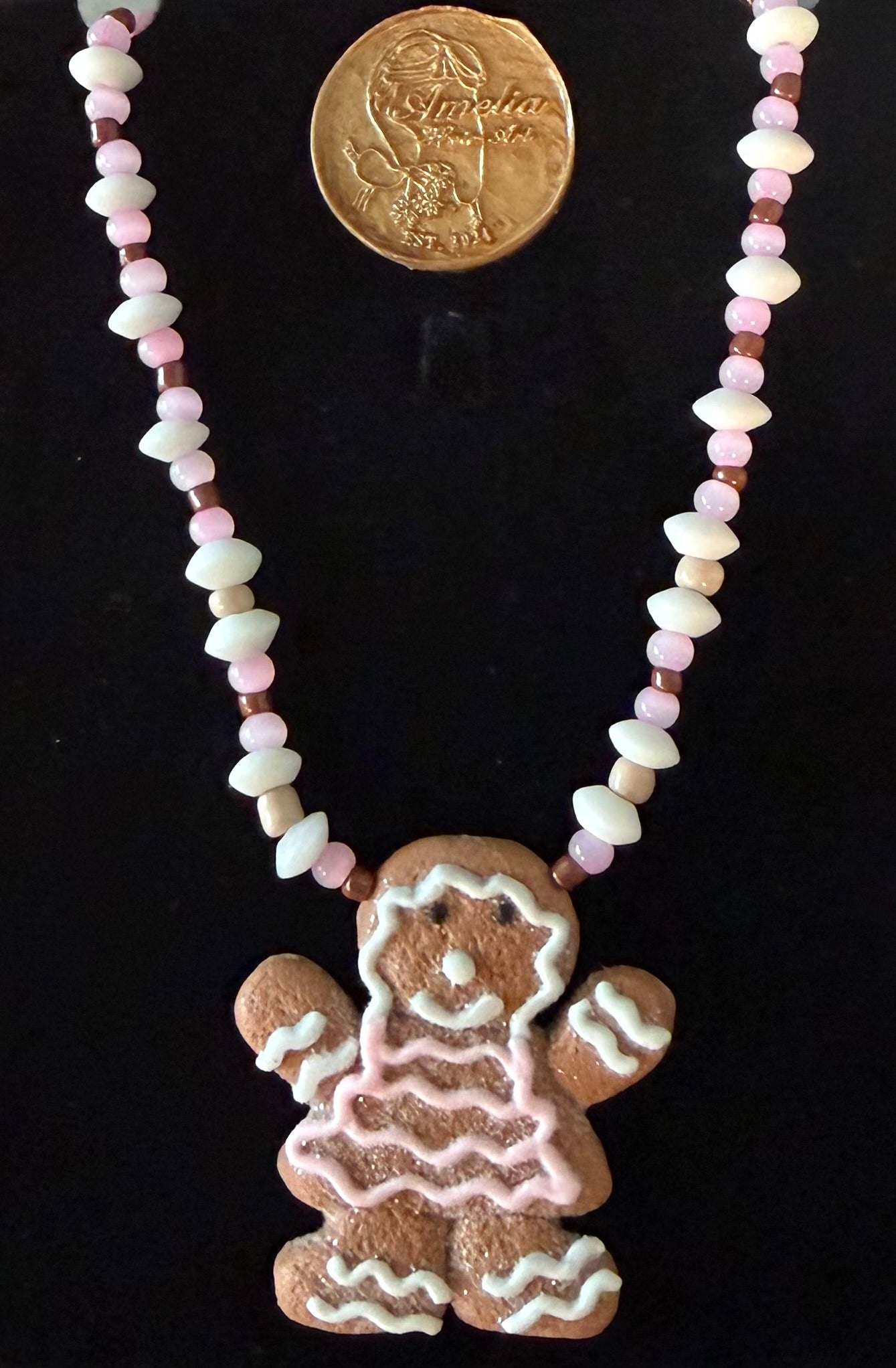 Clara gingerbread woman cookie pendant necklace with pink, white, and brown beads — handmade holiday jewelry by Amelia Heir Art Designs