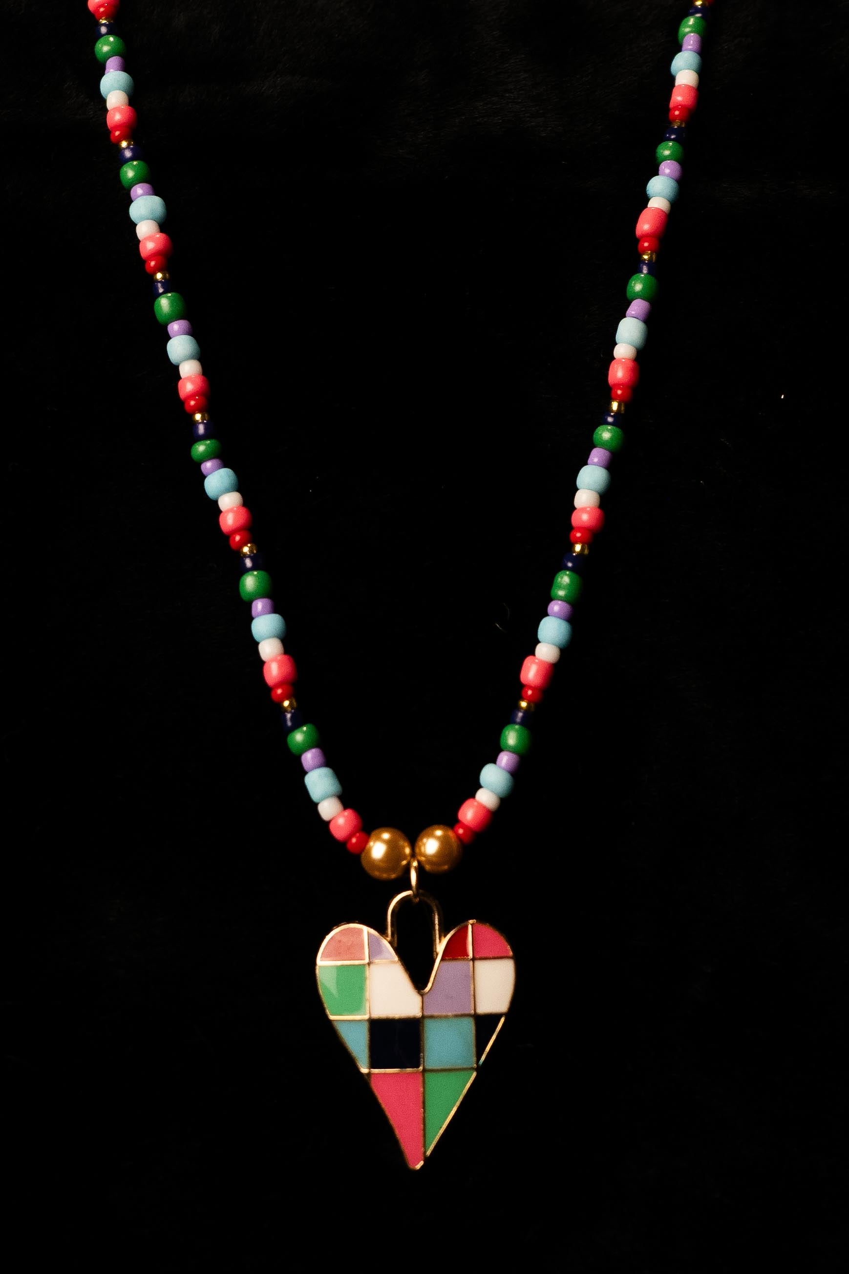 Necklace with a colorful heart pendant on a black background