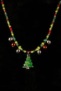 Necklace with a green Christmas tree pendant and tiny jingle bells on a black background