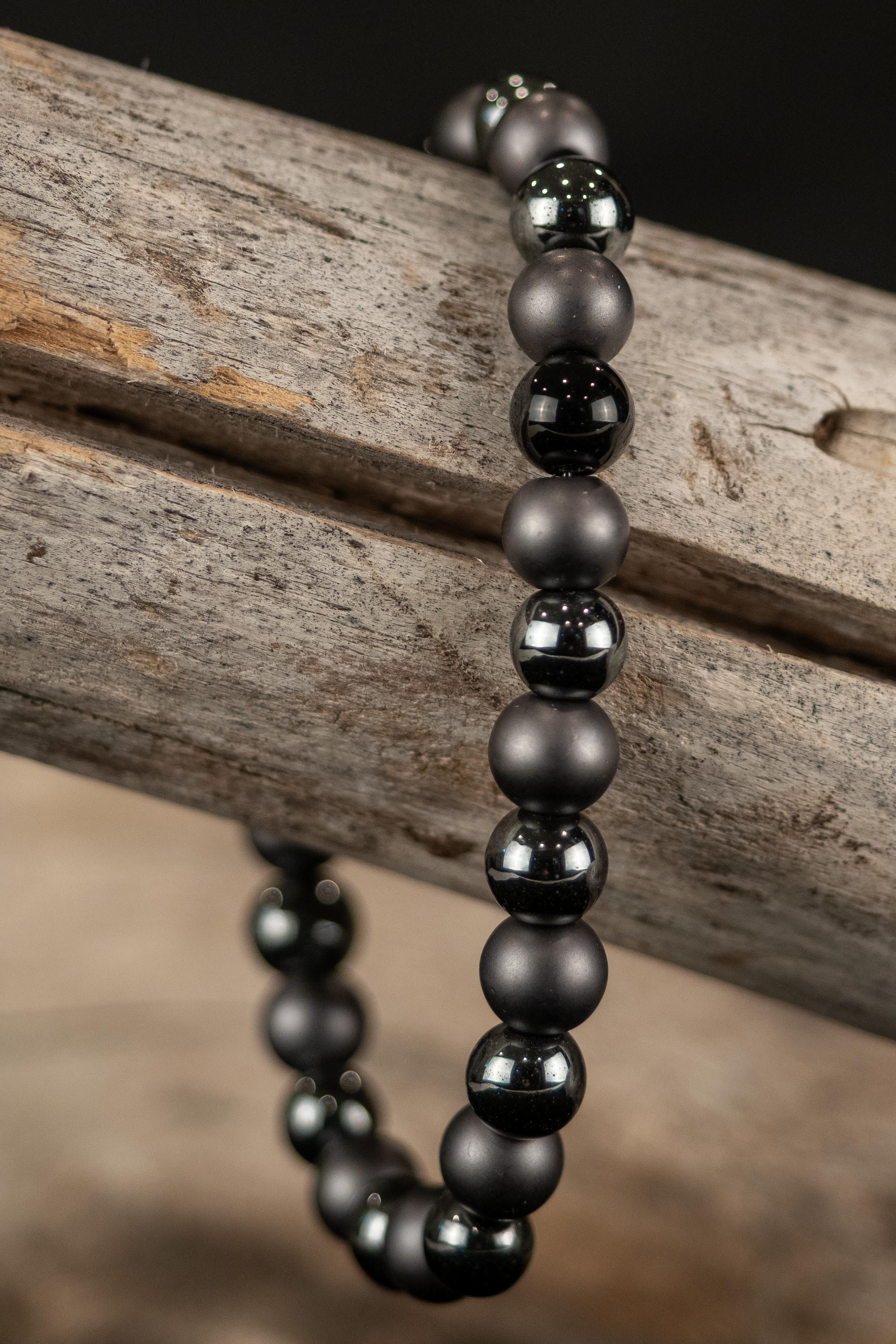 Black beaded bracelet on a wooden surface