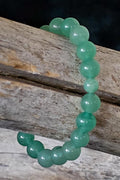 Green beaded bracelet on a wooden surface