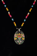 Colorful beaded necklace with a decorative flower patch pendant on a black background