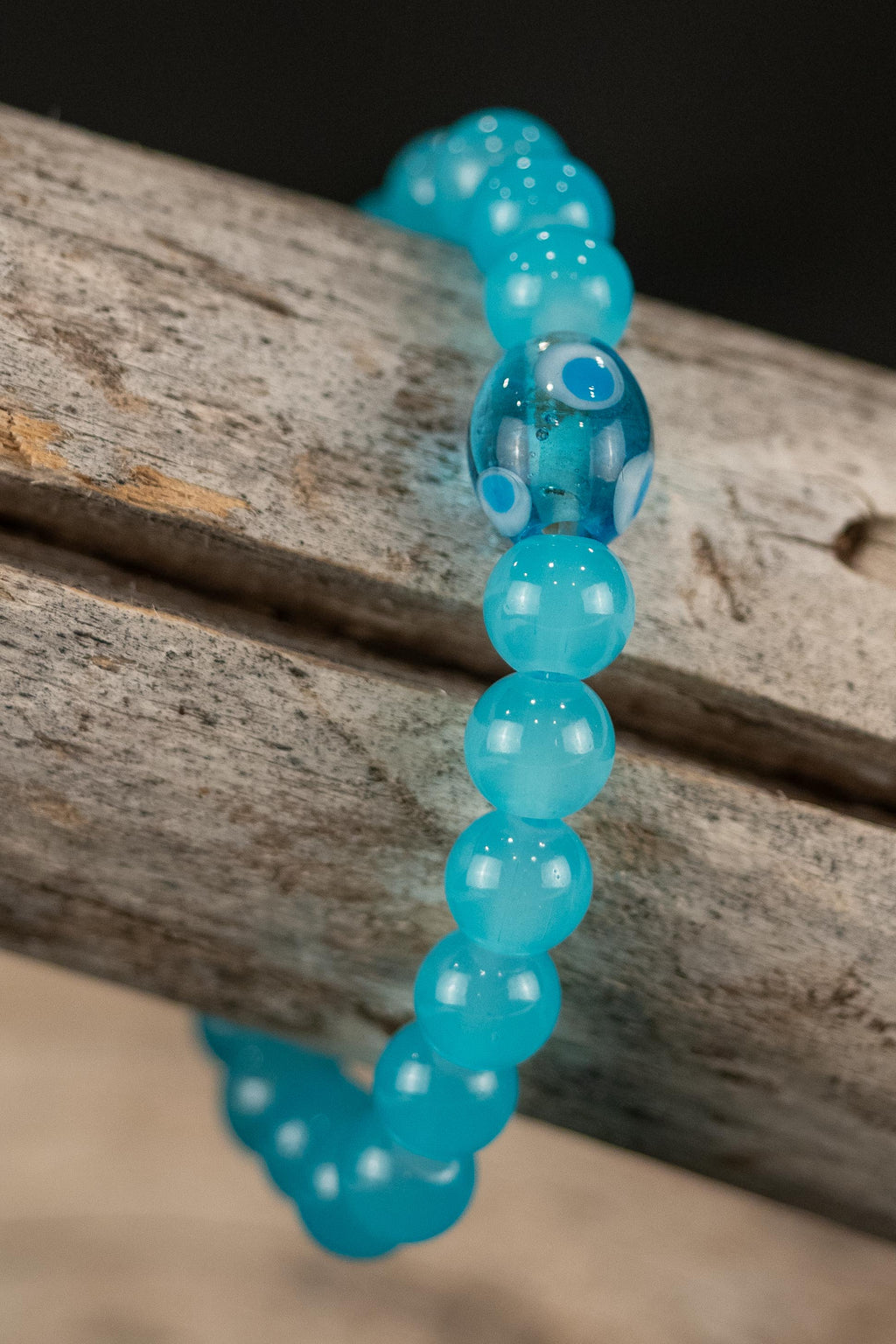 Gary handcrafted blue beaded bracelet on a wooden surface — Amelia Heir Art