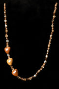 Necklace with heart-shaped beads on a black background
