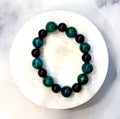 Hogan handcrafted black, green & blue beaded bracelet on a white marble surface — Amelia Heir Art