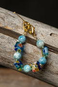 Colorful beaded chain on a wooden surface
