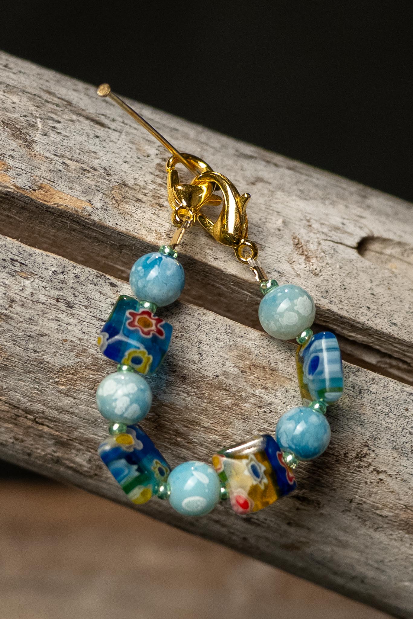 Colorful beaded chain on a wooden surface