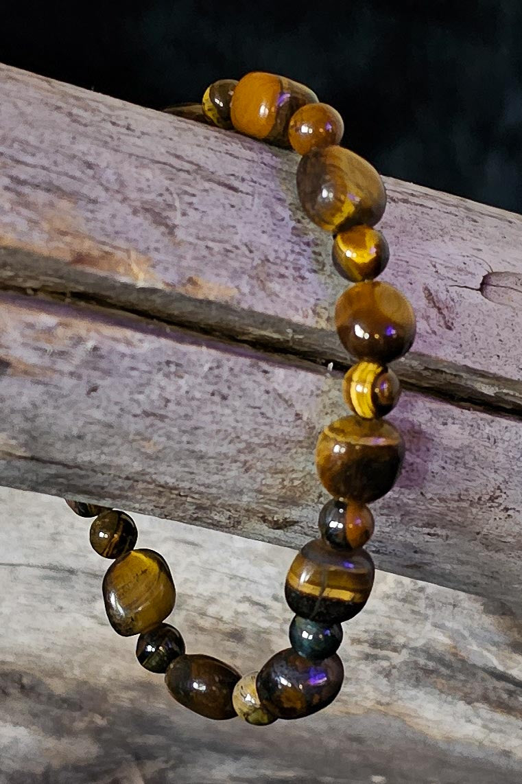 Beaded bracelet with tiger eye stones on a wooden surface