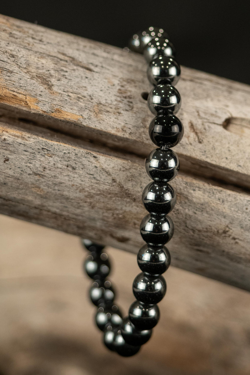 Jeremy handcrafted Black Agate gemstone beaded bracelet on a wooden surface — Amelia Heir Art"