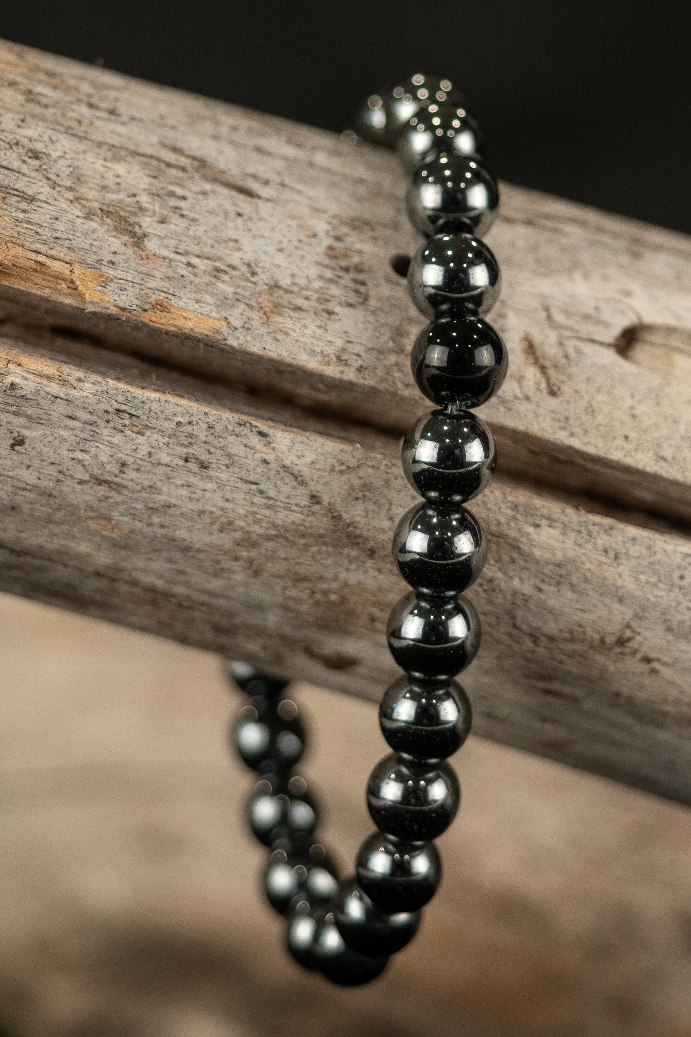 Black beaded bracelet on a wooden surface