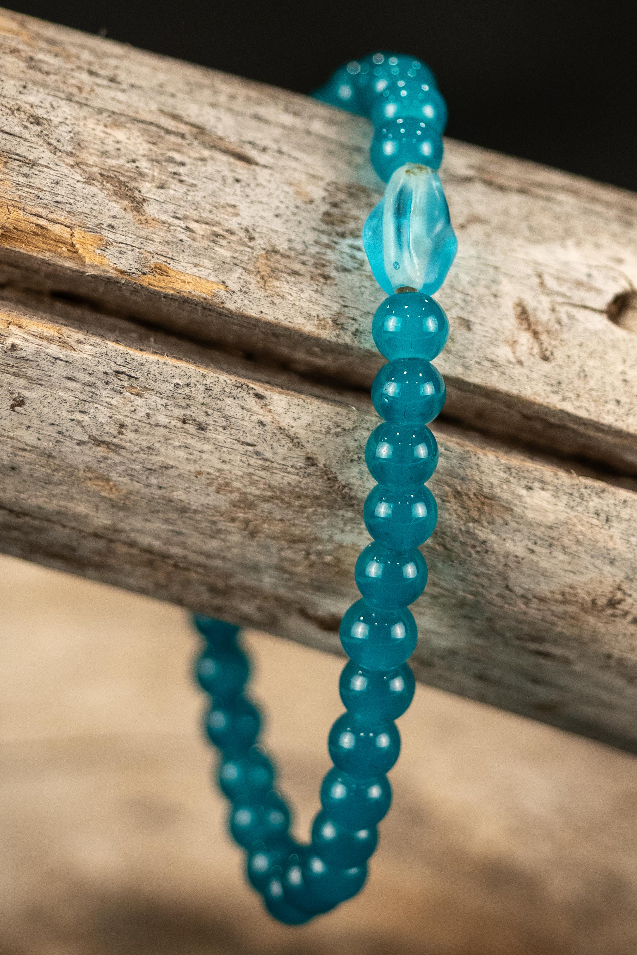 Blue beaded bracelet on a wooden surface