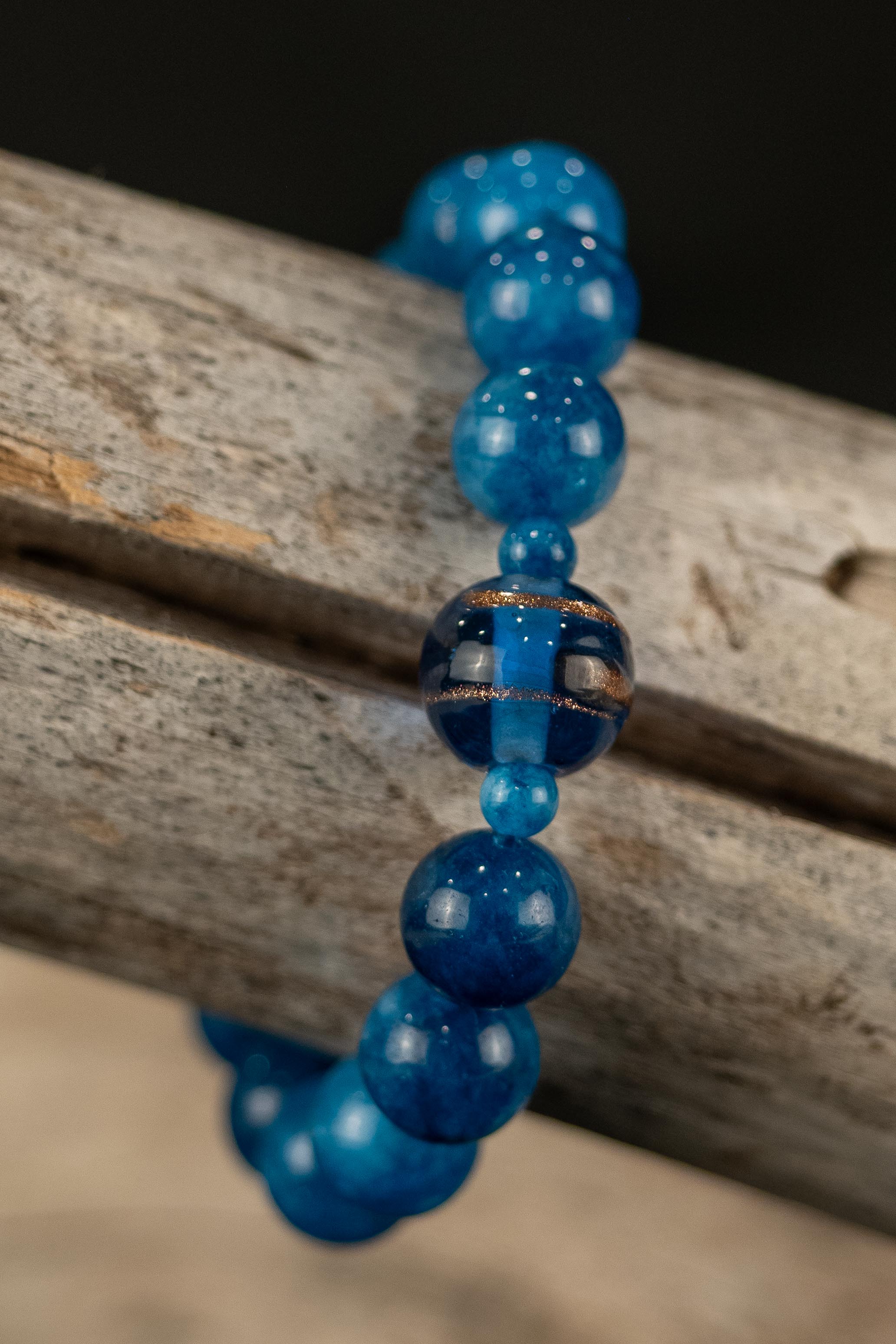 Blue beaded bracelet on a wooden surface