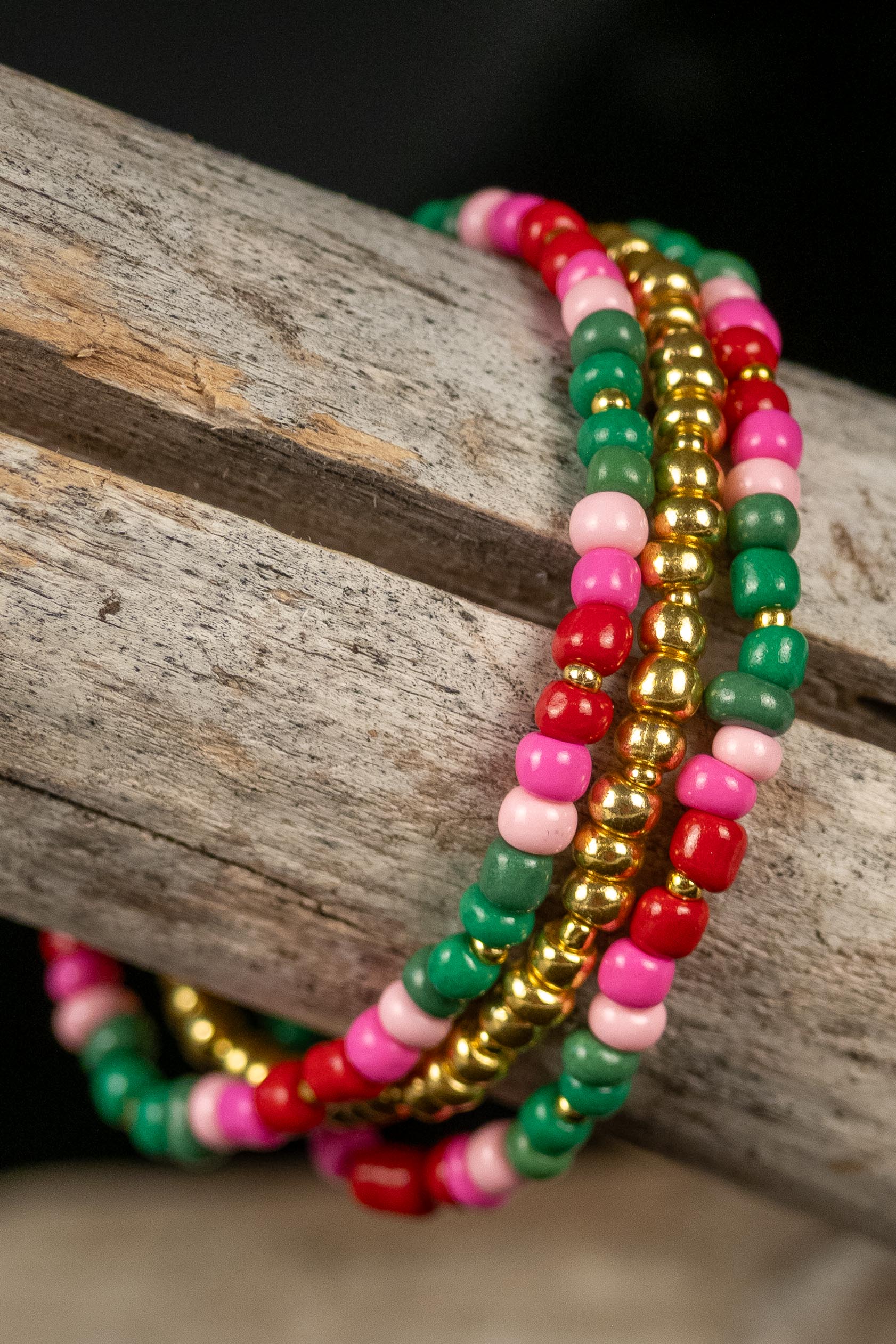 Colorful beaded bracelets on a wooden surface