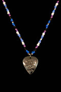 Necklace with pic-shaped pendant and cool multicolored beads on a black background