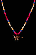 Necklace with colorful beads and a dinosaur pendant on a black background