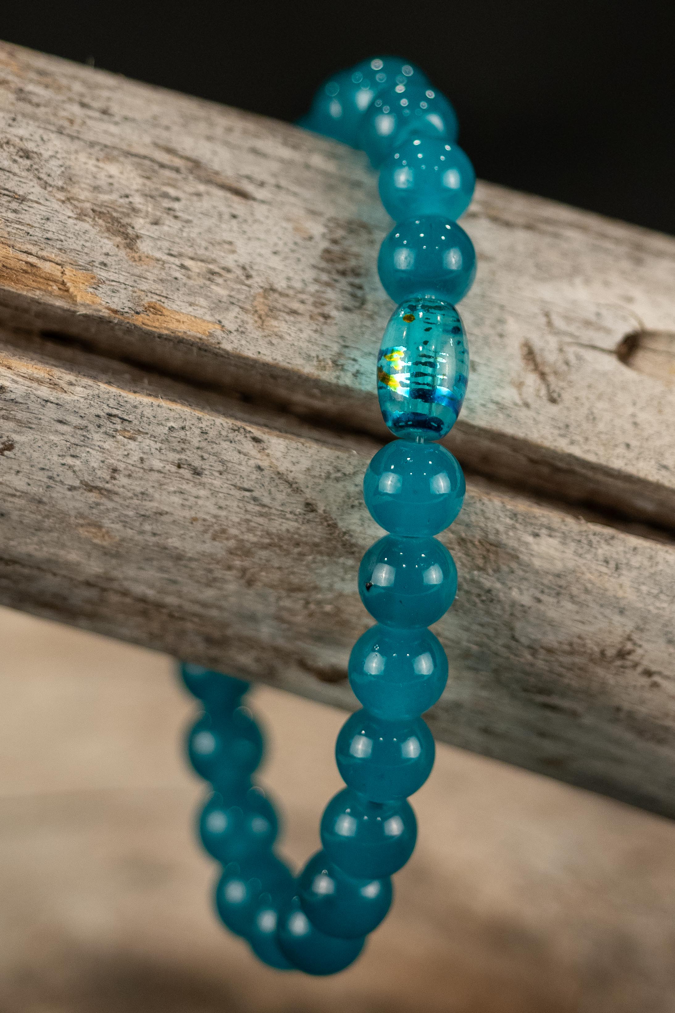 Blue beaded bracelet on a wooden surface