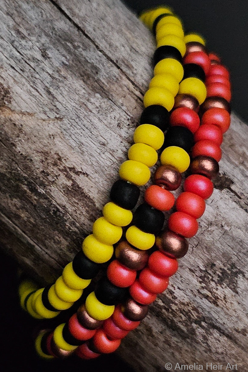 Colorful beaded bracelets on a wooden surface