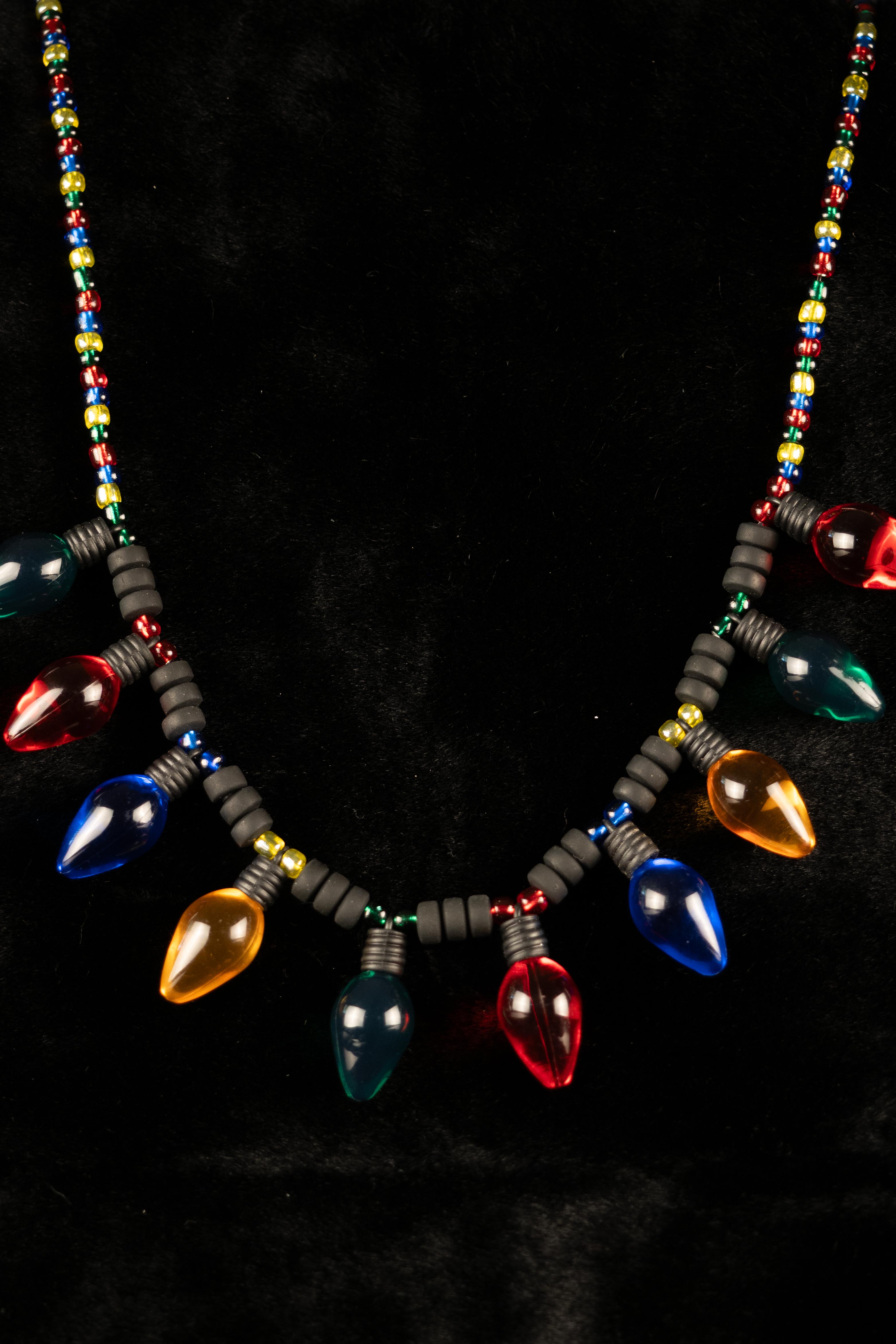 Necklace with colorful light bulb-shaped beads on a black background