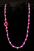 Necklace with purple beads on a black background