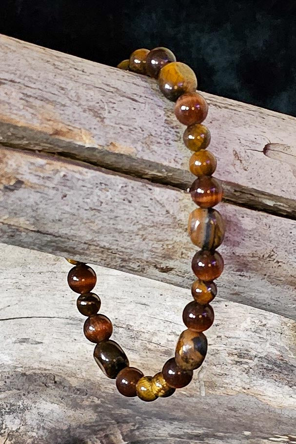 Mike handcrafted warm brown beaded bracelet on a wooden surface — Amelia Heir Art