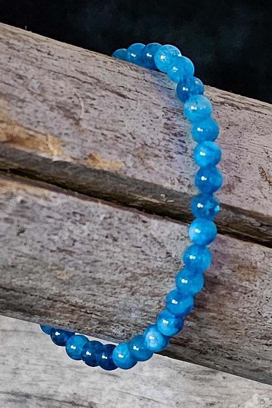 Nathan handcrafted ocean blue beaded bracelet on a wooden surface — Amelia Heir Art