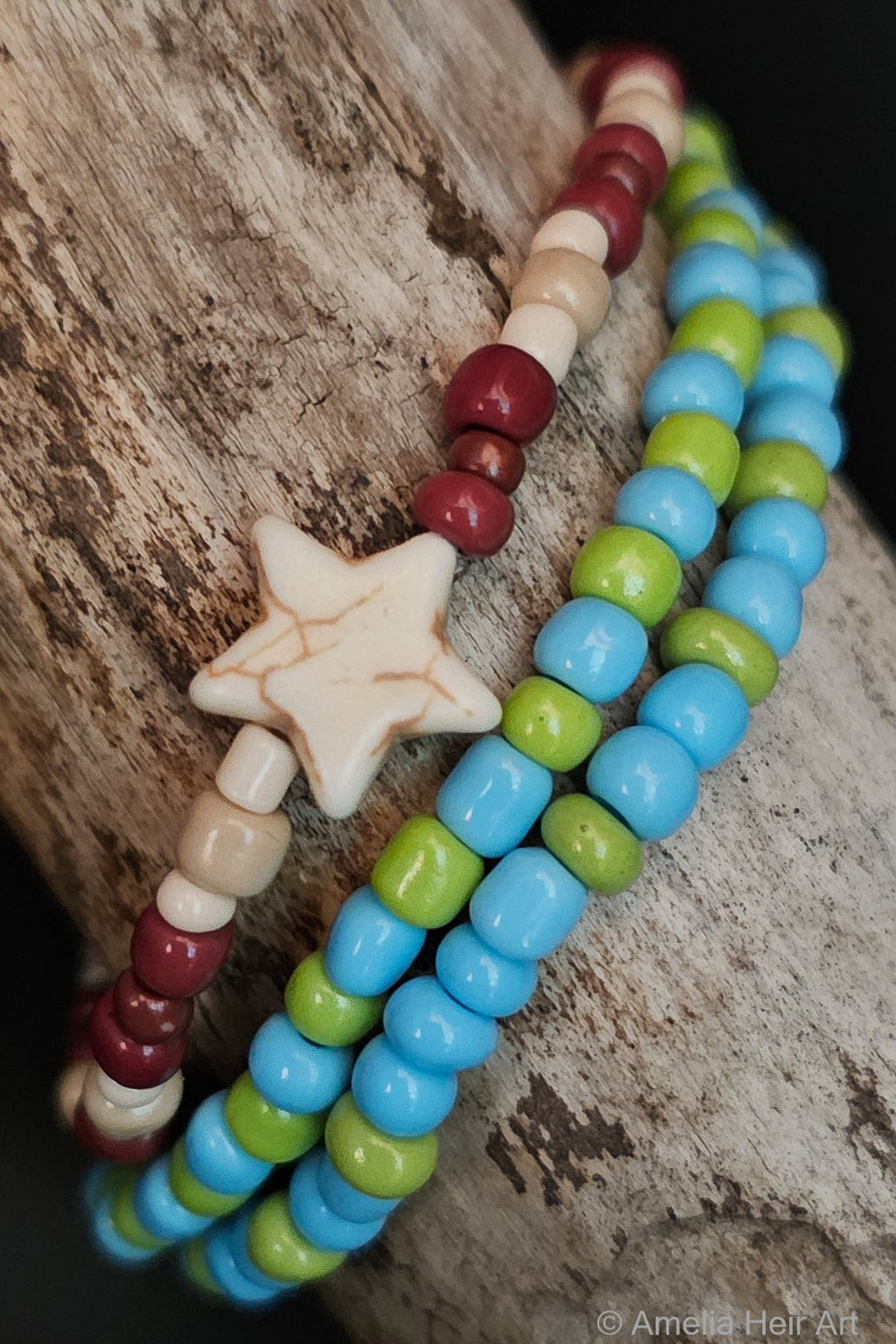 Ocean Side handcrafted blue, green, brown & cream beaded bracelet set with star charm on a wooden surface — Amelia Heir Art