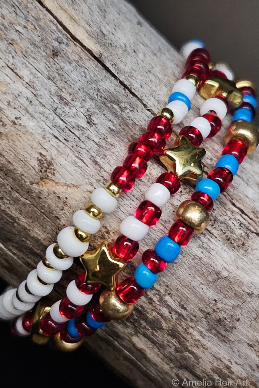 Stack of red, white, and blue beaded bracelets on a wooden surface