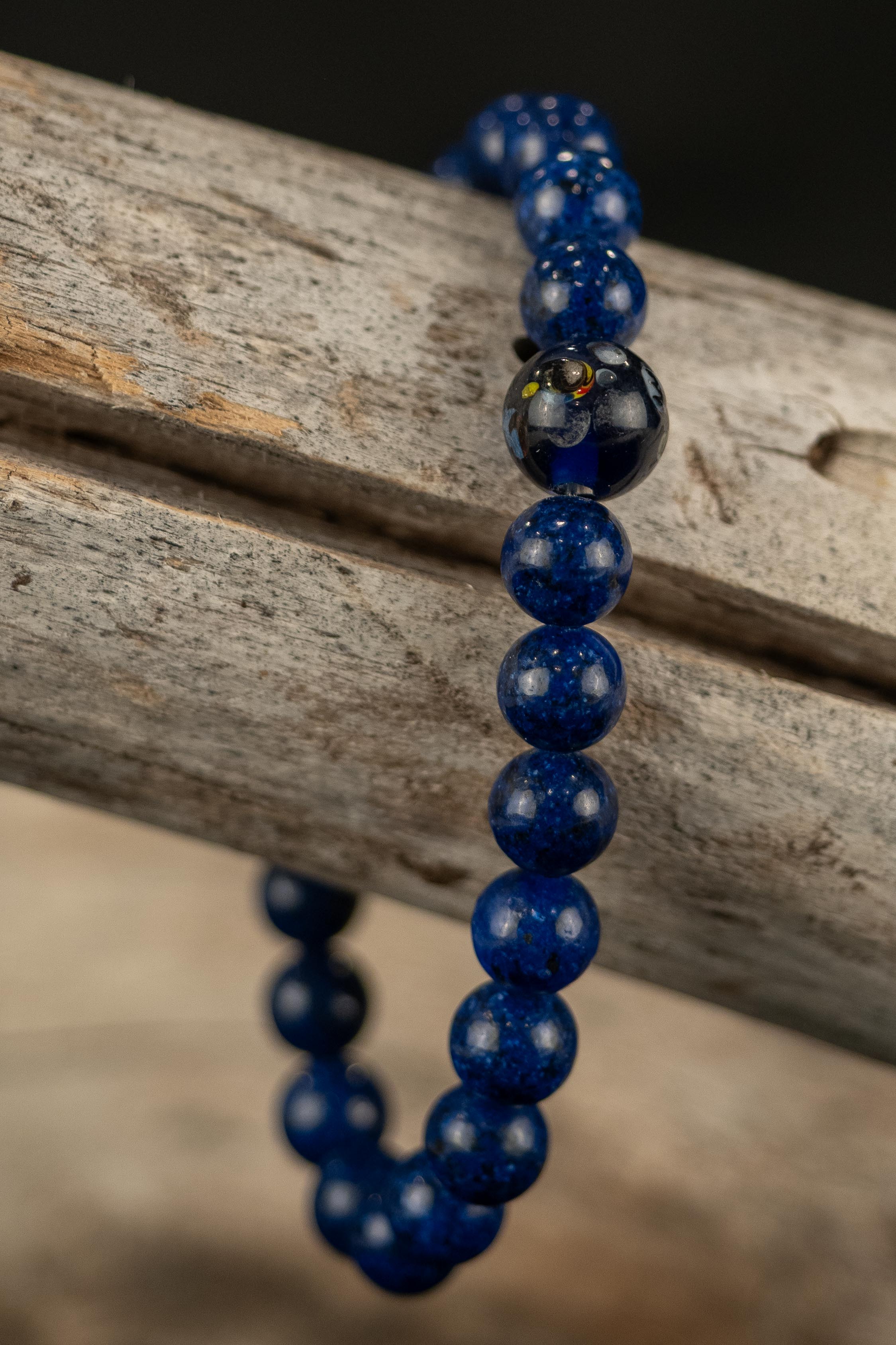 Navy blue beaded bracelet on a wooden surface