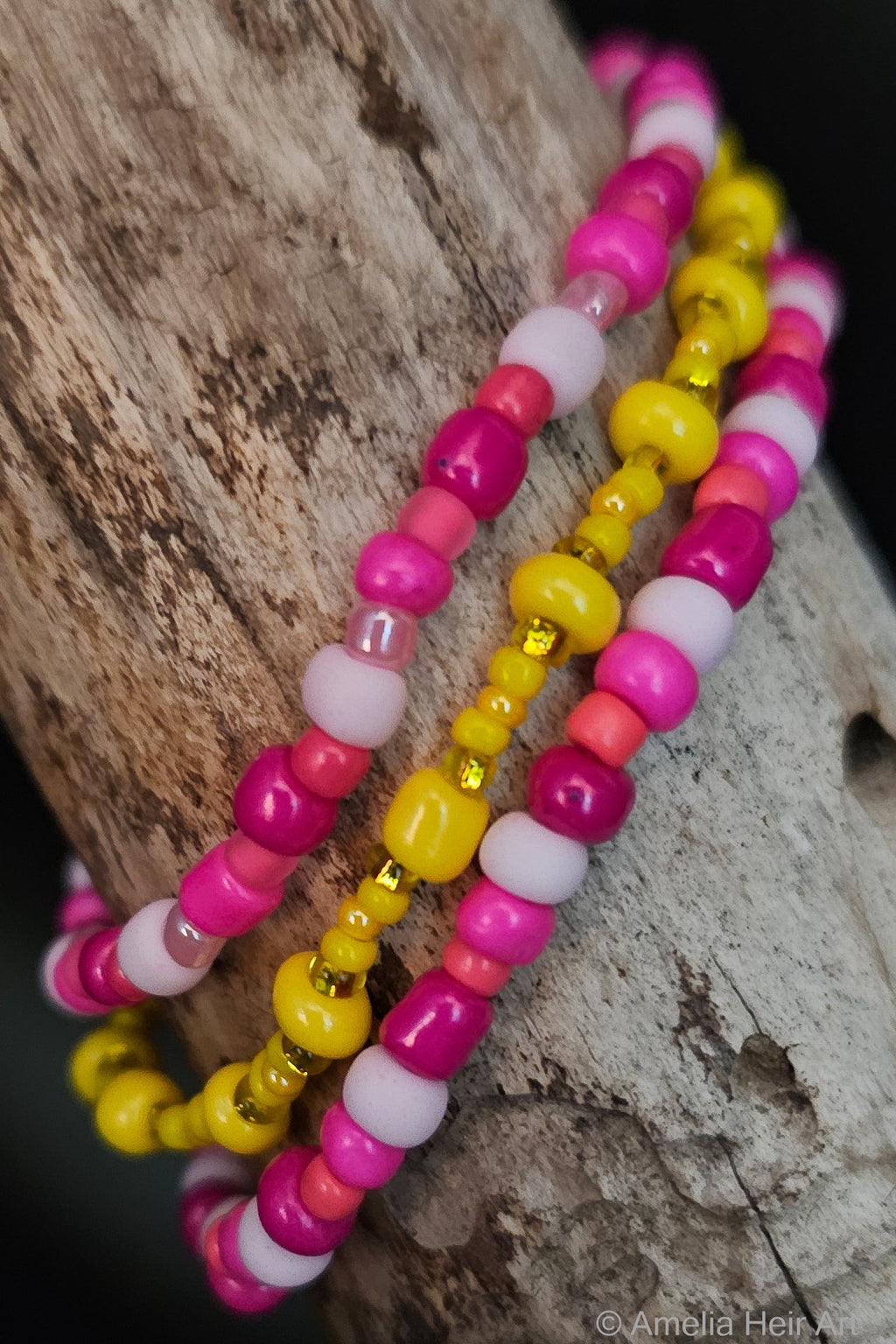 Rivka handcrafted yellow and pink beaded bracelet set on a wooden surface — Amelia Heir Art
