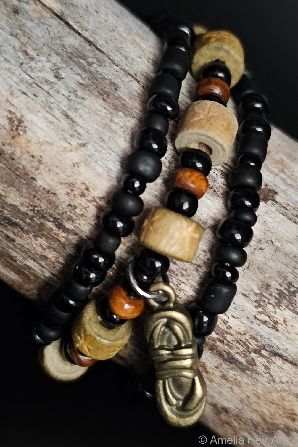 Rope It In handcrafted black brown gold and wood beaded bracelet set on a wooden surface — Amelia Heir Art