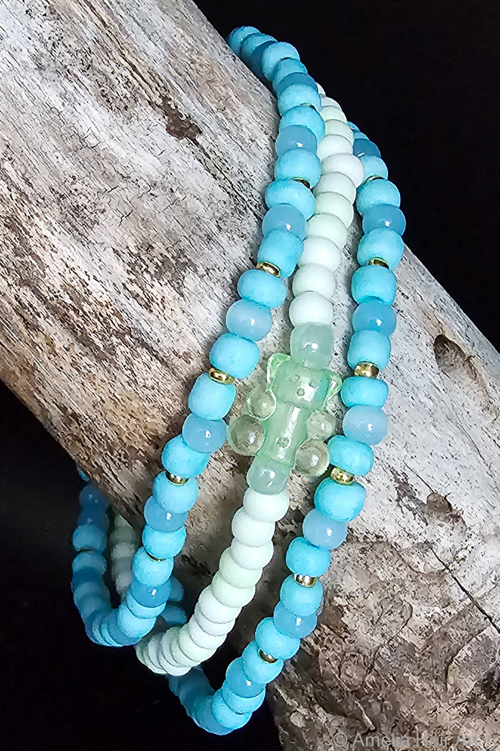 Sara handcrafted white green and blue beaded bracelet set with gummy bear charm on a wooden surface — Amelia Heir Art