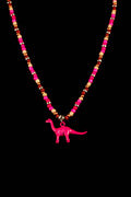 Necklace with colorful beads and a pink dinosaur charm on a black background
