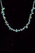 Necklace with turquoise color beads on a black background