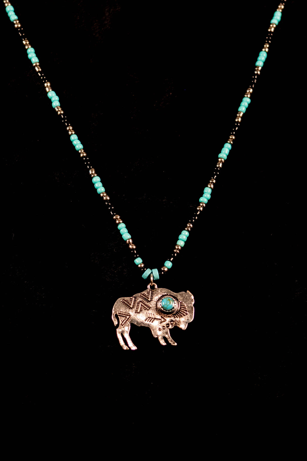 Sofia handcrafted turquoise & bison charm necklace on a black background — Amelia Heir Art
