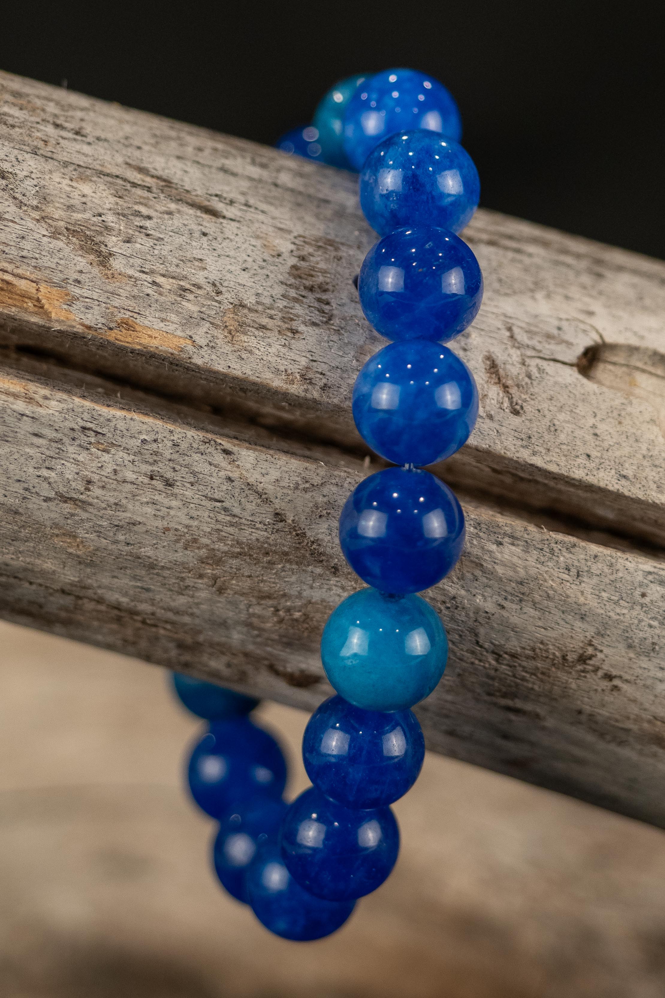 Blue beaded bracelet on a wooden surface
