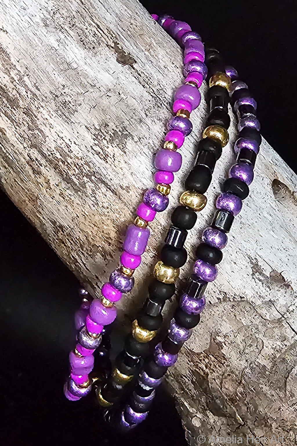 Tavia handcrafted purple, black & gold beaded bracelet set on a wooden surface — Amelia Heir Art