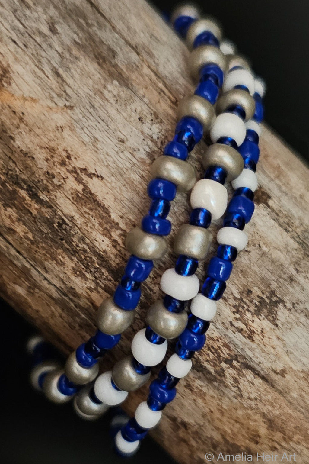 Trust handcrafted blue, white & gray beaded bracelet set on a wooden surface — Amelia Heir Art