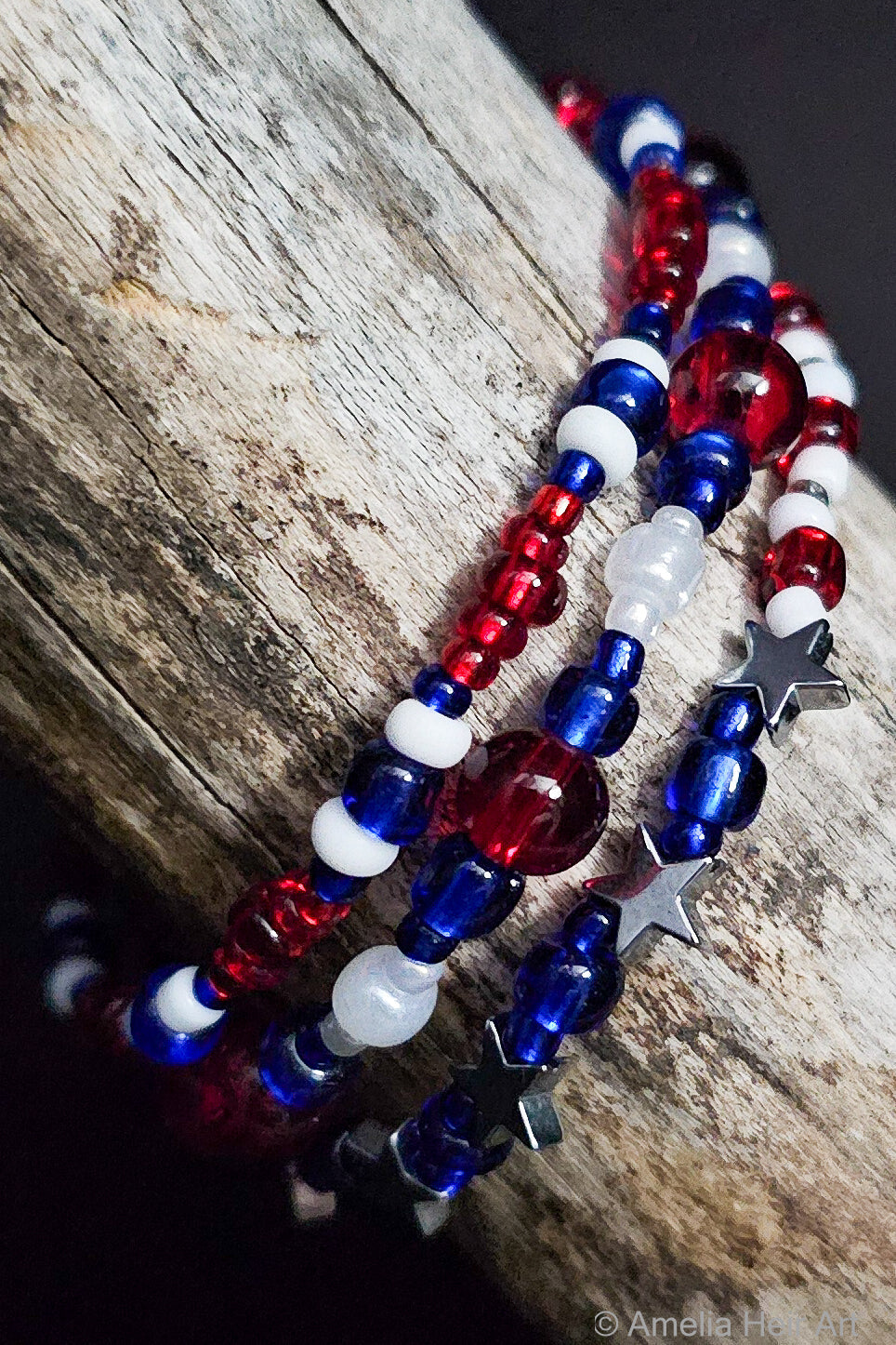 Red, white, and blue beaded bracelets with star accents on a wooden surface